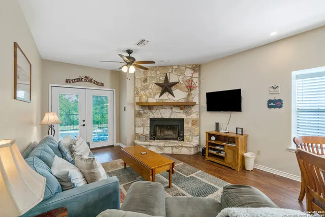a living room with furniture a fireplace and a flat screen tv