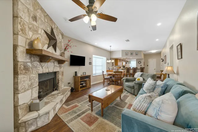 a living room with furniture a fireplace and a flat screen tv