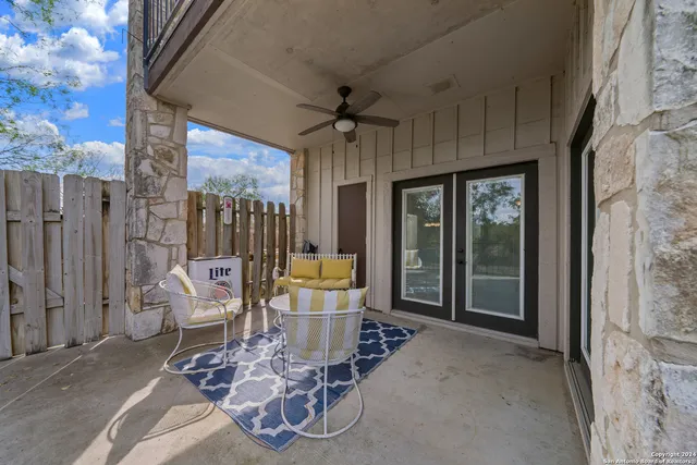 a view of a porch with furniture and next to a yard