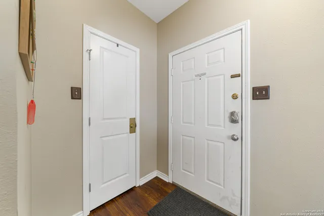 a view of a hallway with wooden floor