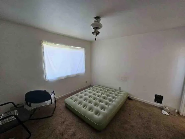 a bedroom with bed and a window