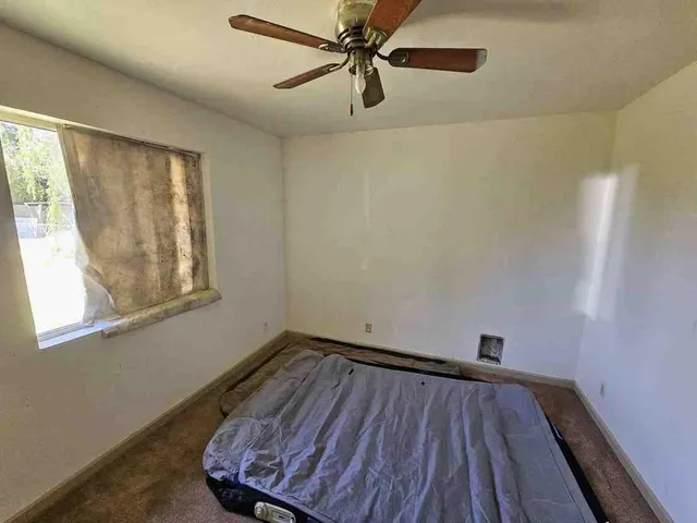 a view of a room with wooden floor and windows