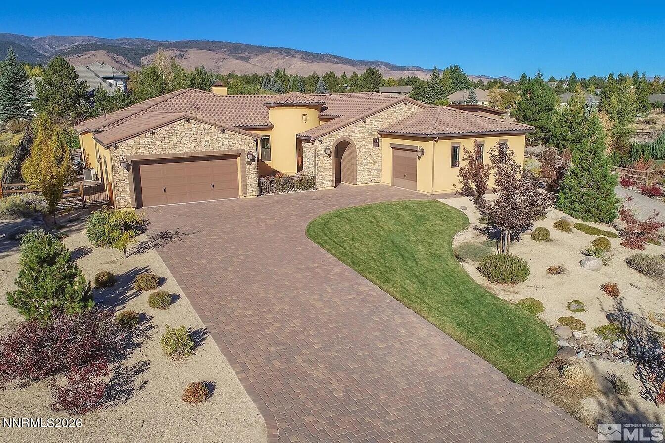 3945 Aspen Reno, NV 89511 - Photo 2 of 21 a view of a white house with a yard plants and large tree