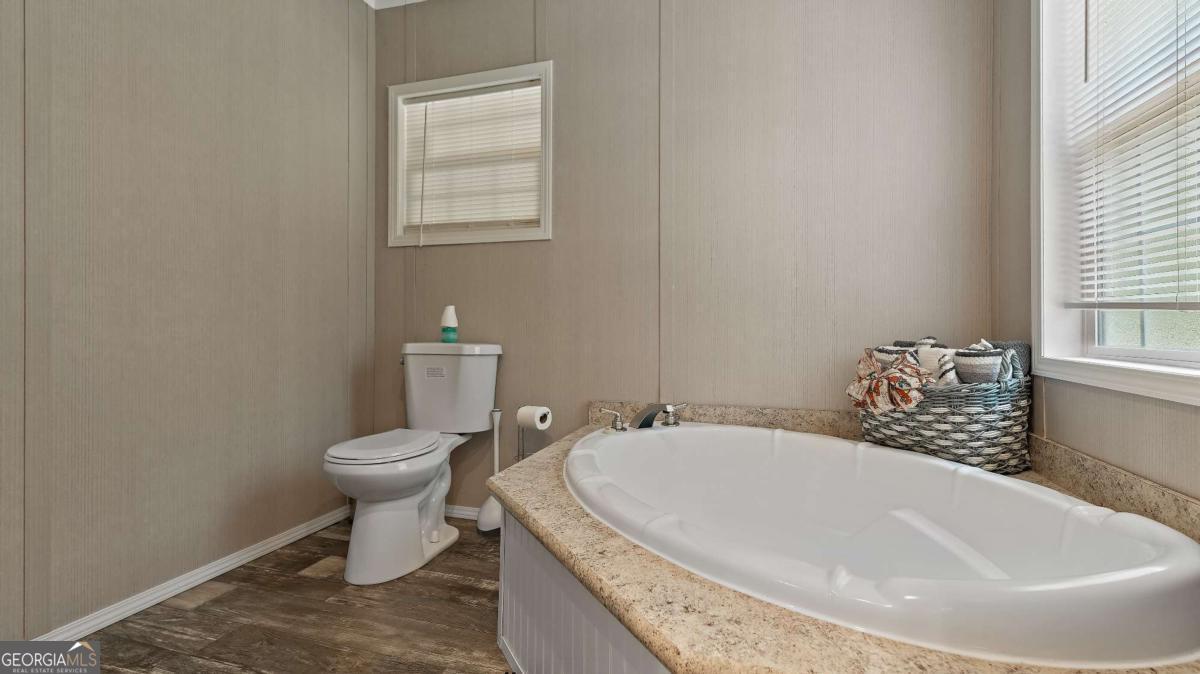 64 Sierra Road Jesup, GA 31545 - Photo 18 of 22 a white bath tub sitting next to a white toilet