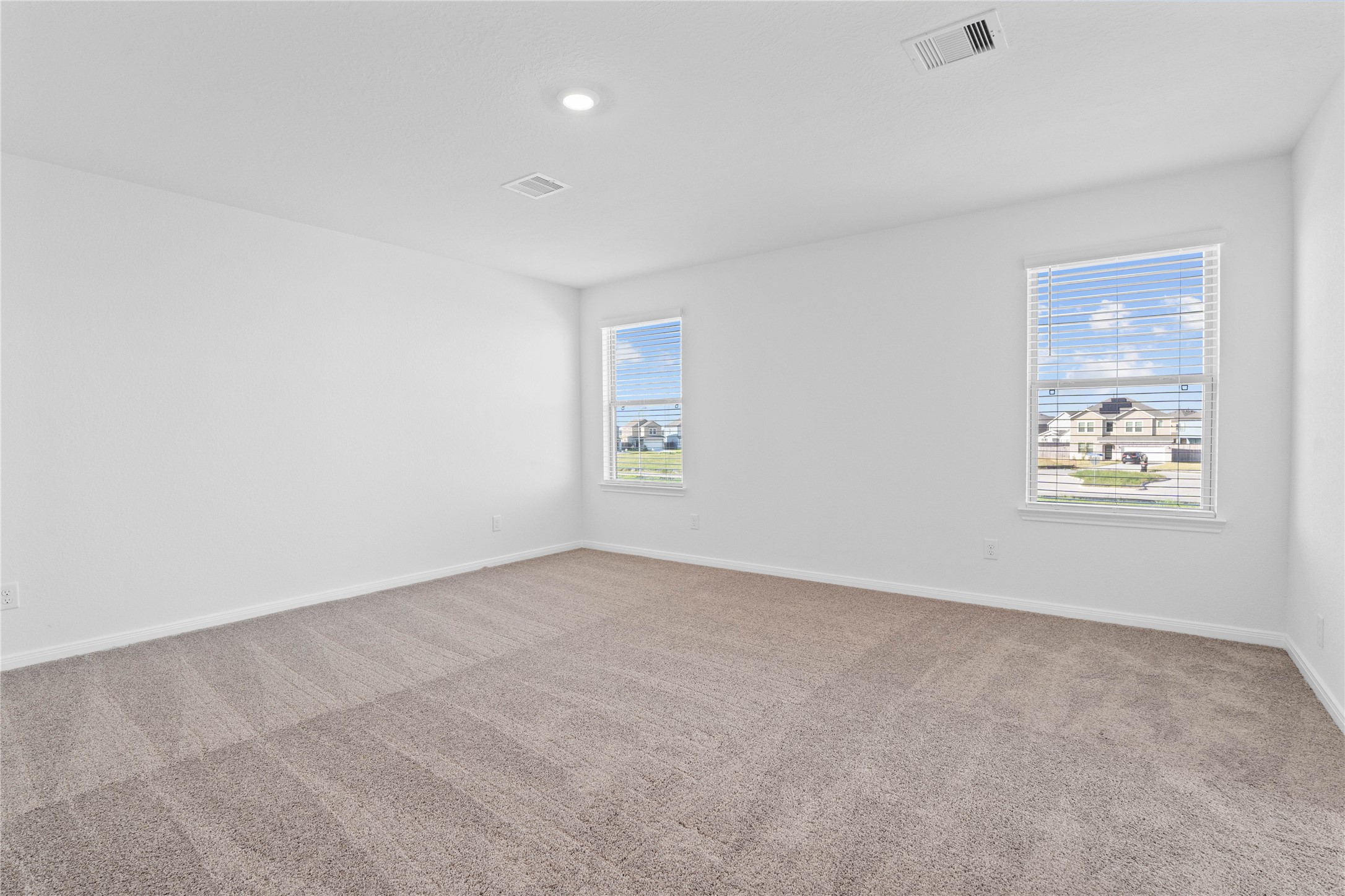 6410 Kentfield Drive Rosharon, TX 77583 - Photo 12 of 25 Relax and recharge in this stunning primary suite! Enjoy the comfort of plush carpeting, neutral-toned walls, high ceilings, recessed lighting, and large windows with privacy blinds that fill the room with natural light.