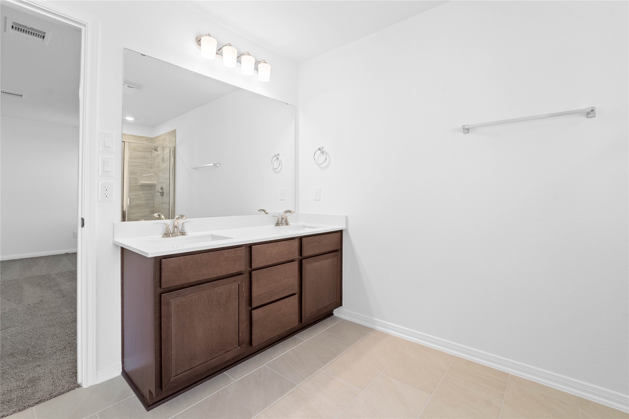 6410 Kentfield Drive Rosharon, TX 77583 - Photo 14 of 25 This stunningly updated primary bathroom is truly move-in ready! It features stained cabinetry with light countertops, dual sinks, a large mirror, high ceilings, custom paint, and sleek modern finishes throughout.