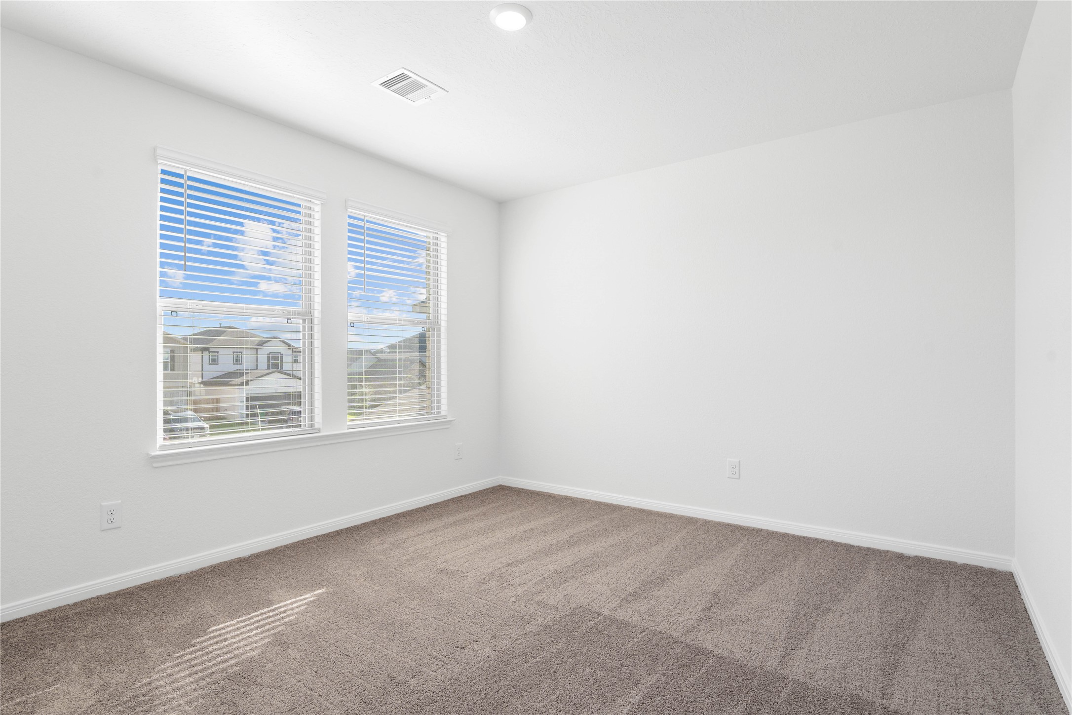 6410 Kentfield Drive Rosharon, TX 77583 - Photo 19 of 25 This secondary bedroom offers comfort and style with plush carpeting, neutral paint tones, recessed lighting, large windows with blinds, and a generously sized closet.