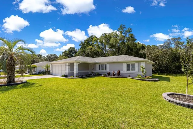 a front view of a house with yard and swimming pool