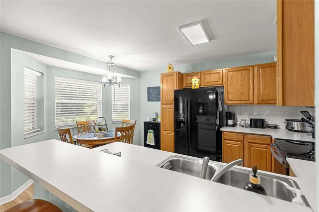 a kitchen with stainless steel appliances granite countertop a refrigerator stove microwave and sink
