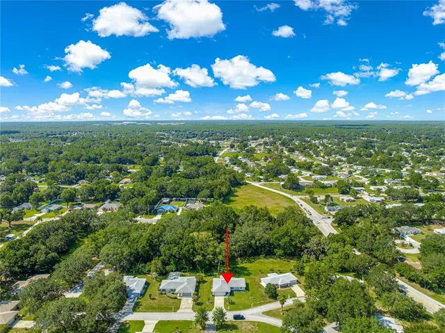 a room with lots of wooden furniture and stainless steel appliances
