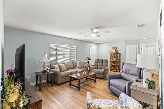 a view of a livingroom with furniture window and wooden floor