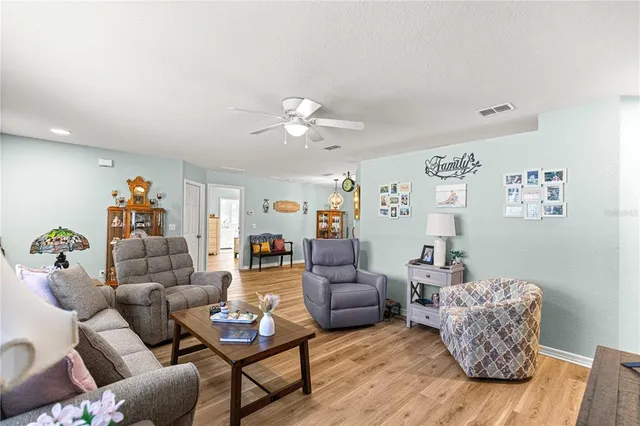 a view of a livingroom with furniture wooden floor and a window