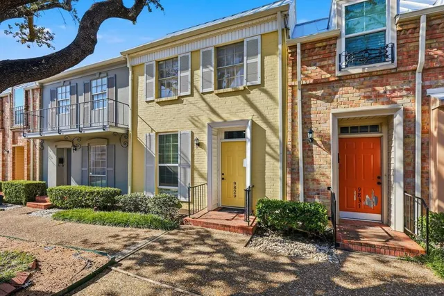 a front view of a brick house with a yard