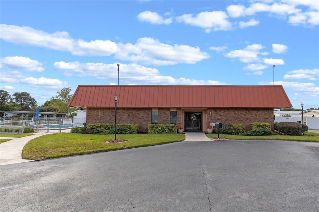 3026 Myakka River Road Tavares, FL 32778 - Photo 35 of 49 a view of a house with a yard and a car park fire pit