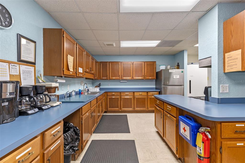 3026 Myakka River Road Tavares, FL 32778 - Photo 40 of 49 a kitchen with stainless steel appliances granite countertop a sink a stove and a wooden cabinets
