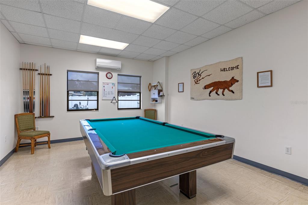 3026 Myakka River Road Tavares, FL 32778 - Photo 43 of 49 a room with pool table and paintings on the wall