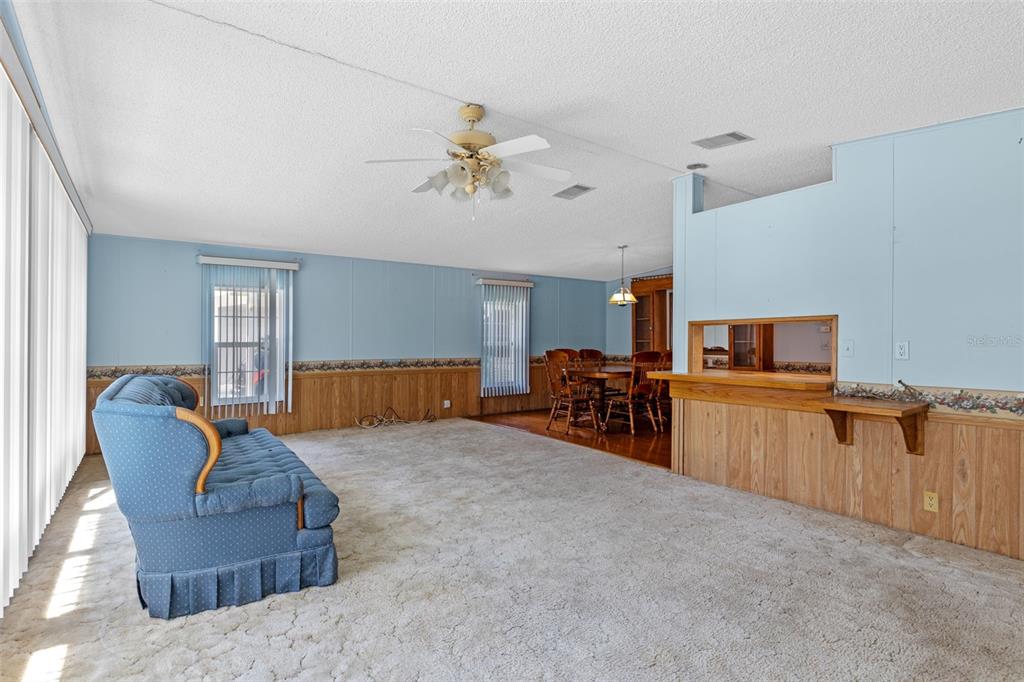 3026 Myakka River Road Tavares, FL 32778 - Photo 7 of 49 a living room with furniture and a flat screen tv