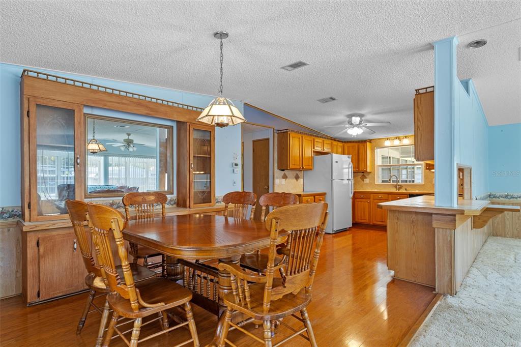 3026 Myakka River Road Tavares, FL 32778 - Photo 9 of 49 a view of a dining room with furniture window and wooden floor