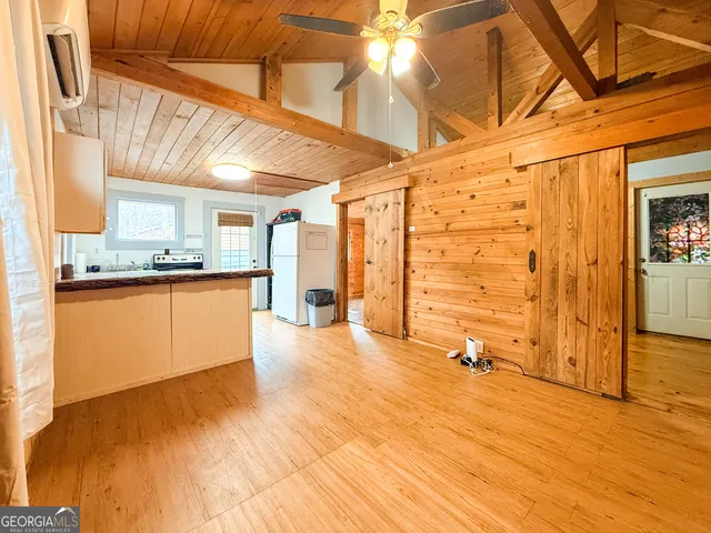 a view of a kitchen with wooden floor and a sink
