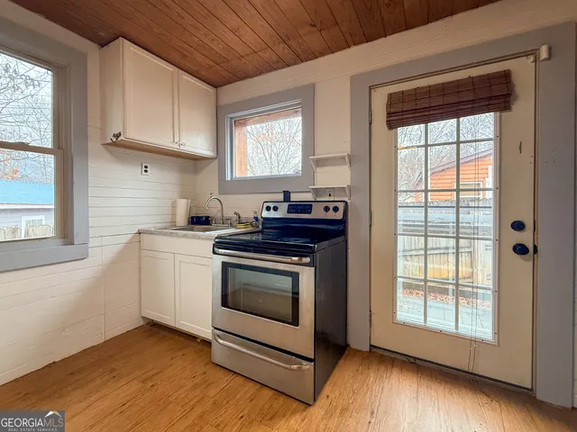 a kitchen with a stove and a white cabinet