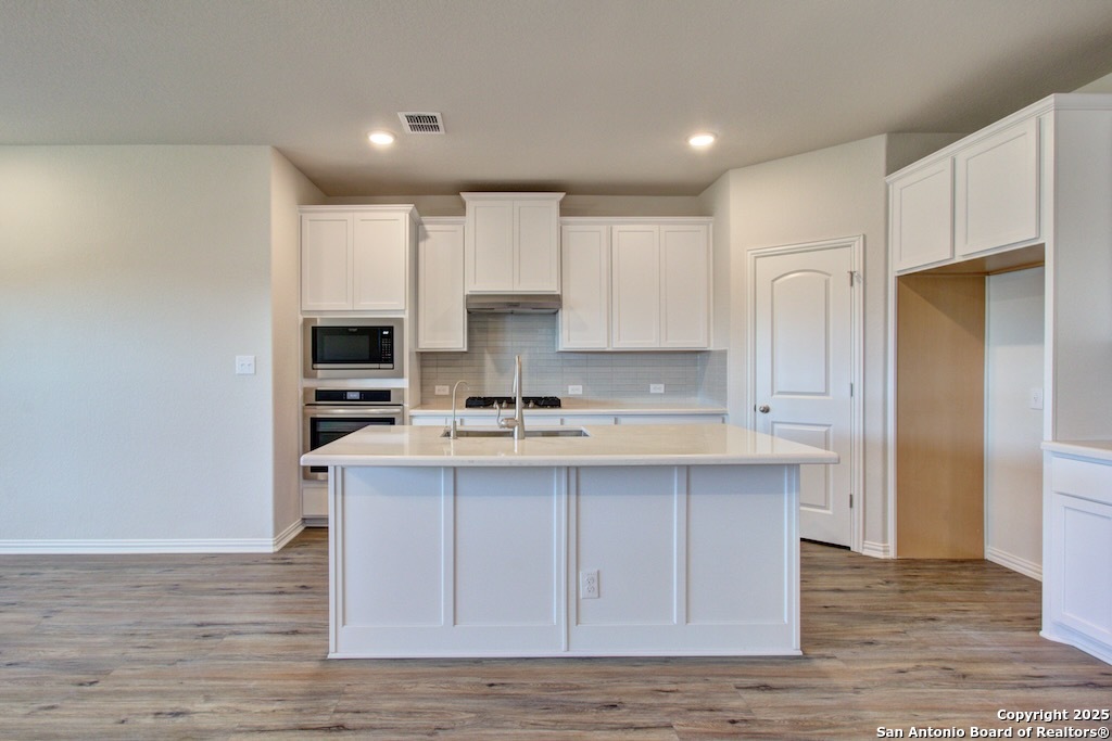2118 Shepards Street Seguin, TX 78155 - Photo 3 of 22 a kitchen with kitchen island granite countertop a sink cabinets and stainless steel appliances