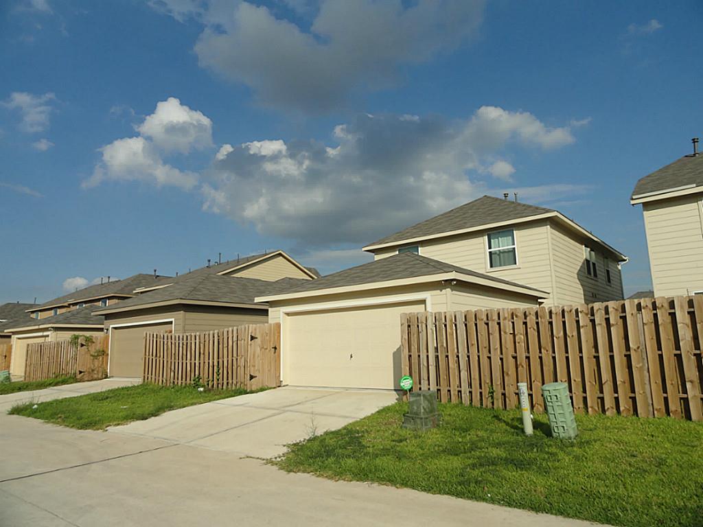 7326 Granite Terrace Lane Houston, TX 77083 - Photo 36 of 39 a front view of a house with a yard and garage