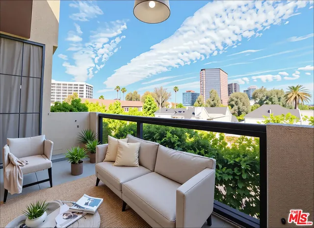 a balcony with furniture and a large window