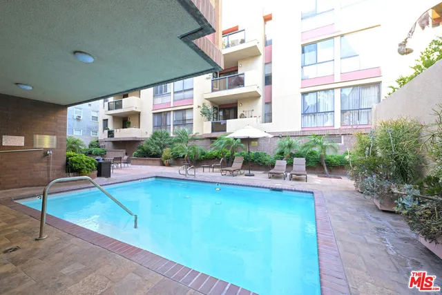 swimming pool view with a seating space
