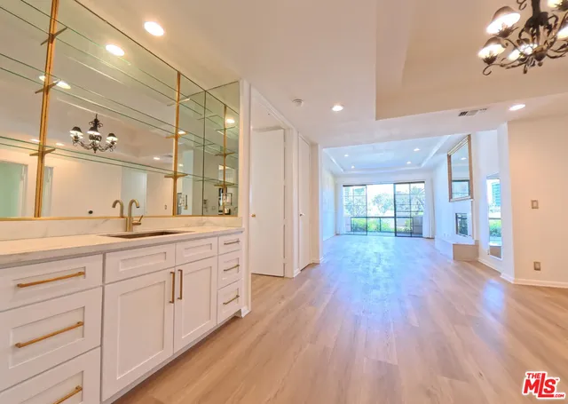 a bathroom with a granite countertop sink and a large mirror