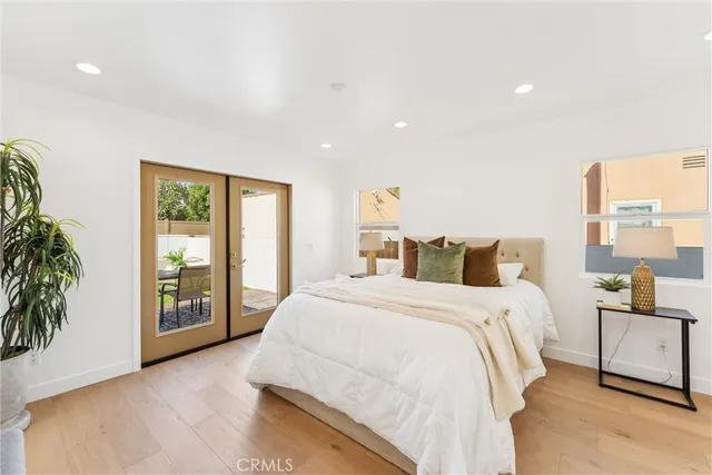 a spacious bedroom with a bed and a large window