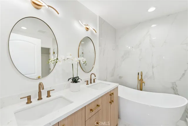 a bathroom with a double vanity sink and a mirror