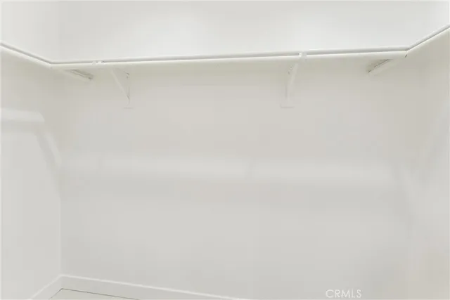 a bedroom with a bed and potted plant