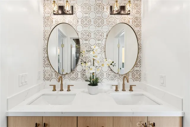 a bathroom with a sink double vanity and a mirror