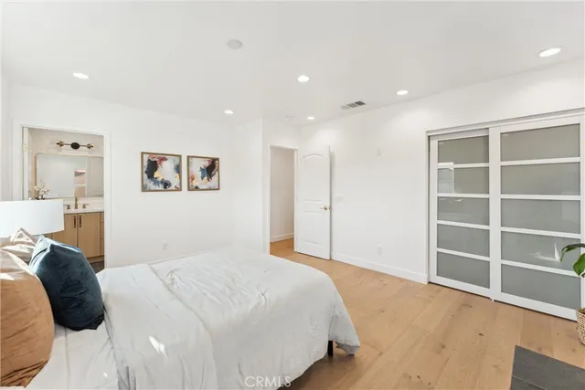 a bathroom with a granite countertop sink toilet a mirror a vanity and shower
