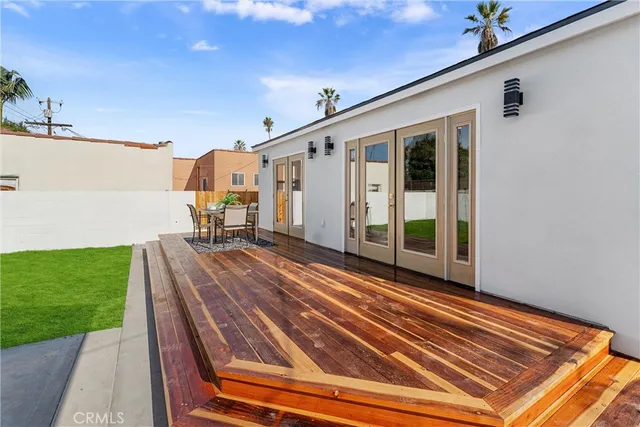 a view of a patio with table and chairs potted plants with wooden floor