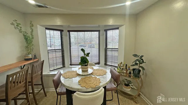 a view of a dining room with furniture and window