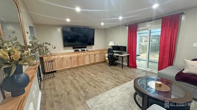 a living room with furniture a flat screen tv and a large window