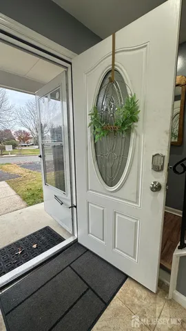 a view of a livingroom with wooden floor and white walls
