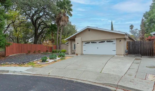 a view of a house with a yard and garage