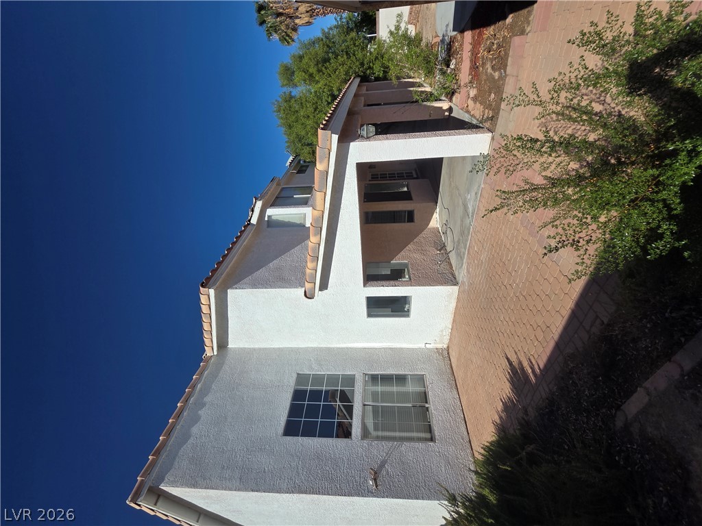1429 Hawkwood Road Henderson, NV 89014 - Photo 52 of 53 Stucco exterior finishes and tiled rooflines frame the side profile of this multi-level home.