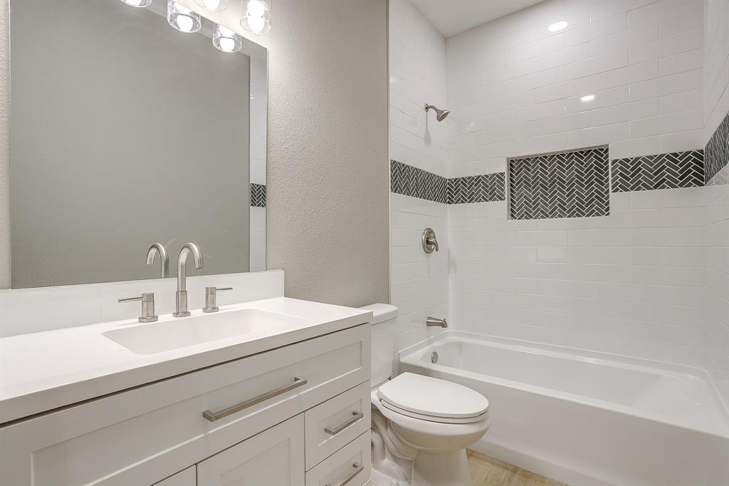 1040 Rays Way Weatherford, TX 76085 - Photo 16 of 20 White vanity with brushed nickel hardware, integrated rectangular sink, and two-handle faucet