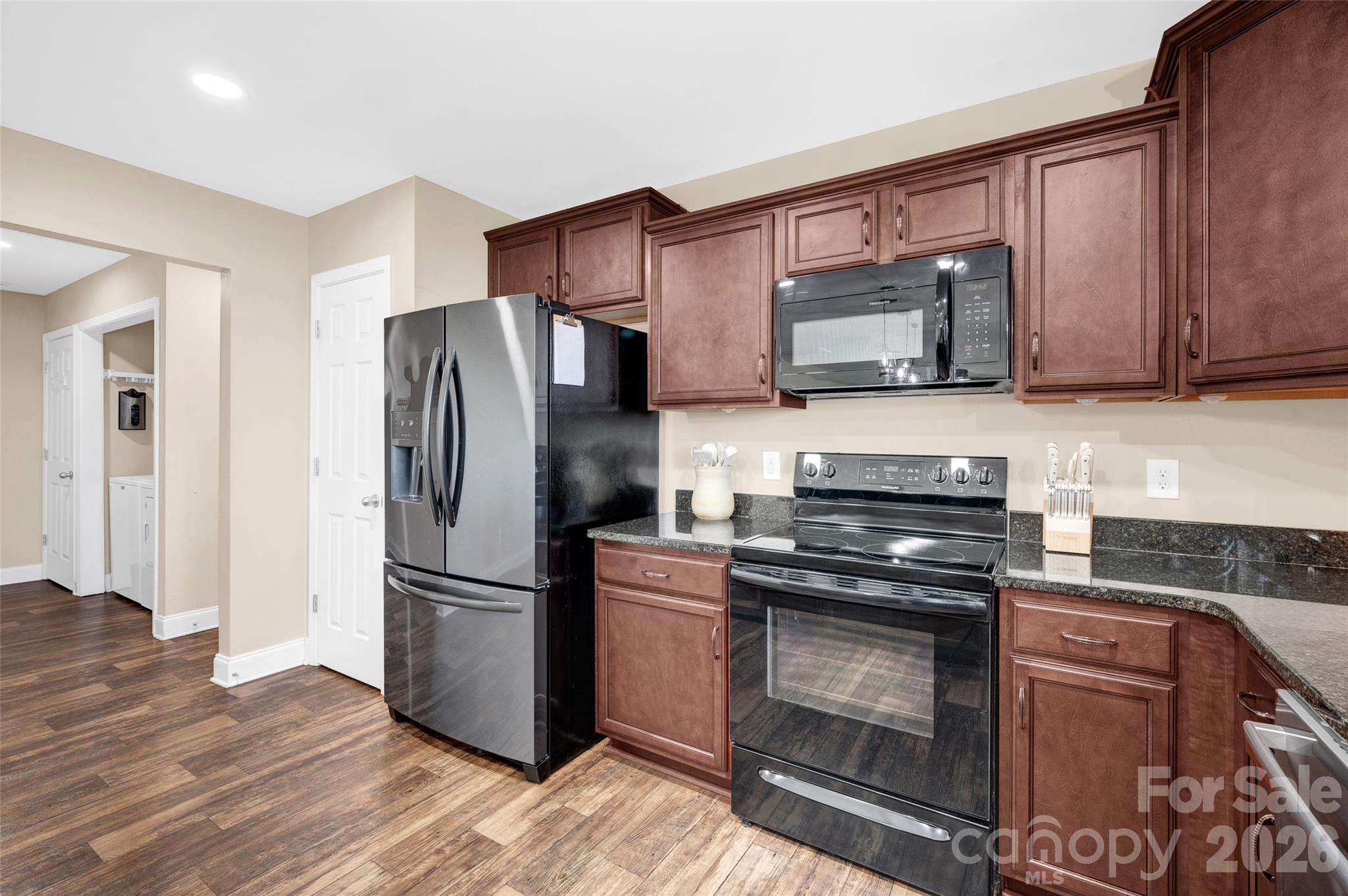 359 Rash Road Olin, NC 28660 - Photo 14 of 46 a kitchen with wooden cabinets and stainless steel appliances