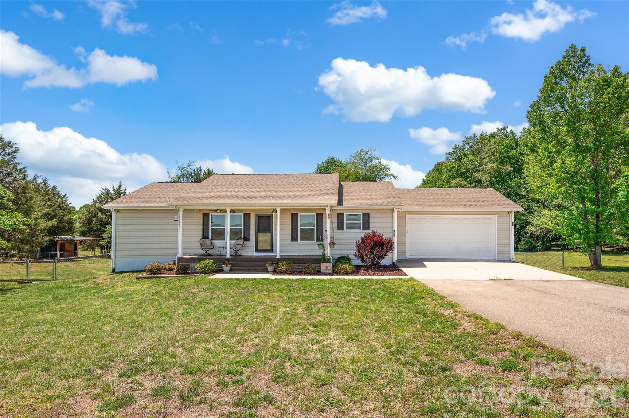 359 Rash Road Olin, NC 28660 - Photo 2 of 46 a front view of a house with a yard and trees