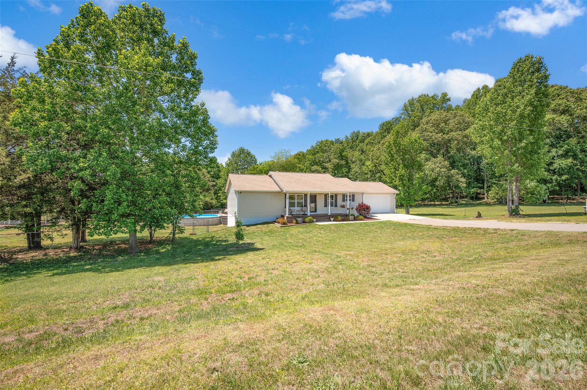 359 Rash Road Olin, NC 28660 - Photo 3 of 46 a swimming pool with trees in the background