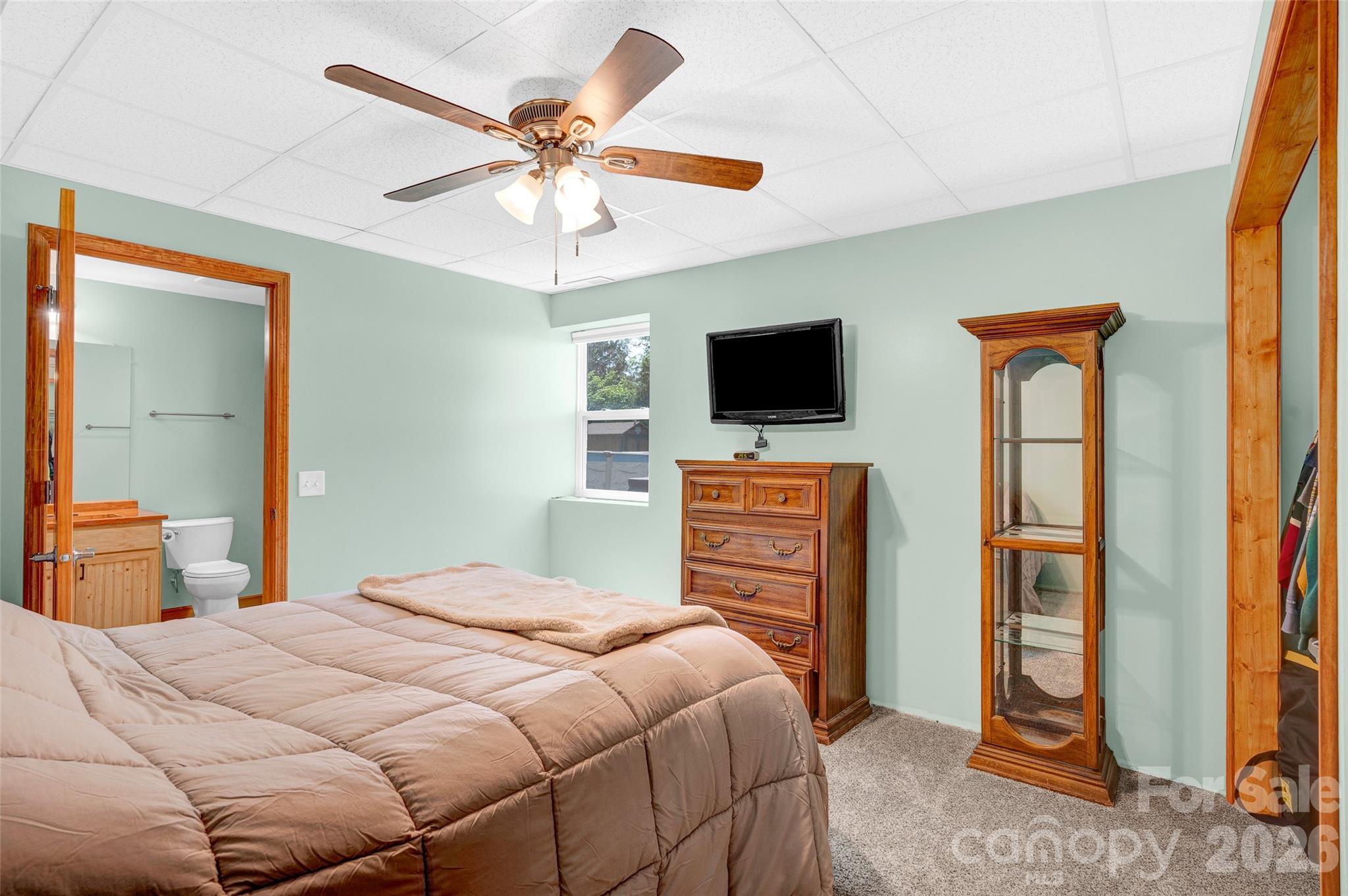 359 Rash Road Olin, NC 28660 - Photo 32 of 46 a bedroom with a bed and a flat screen tv