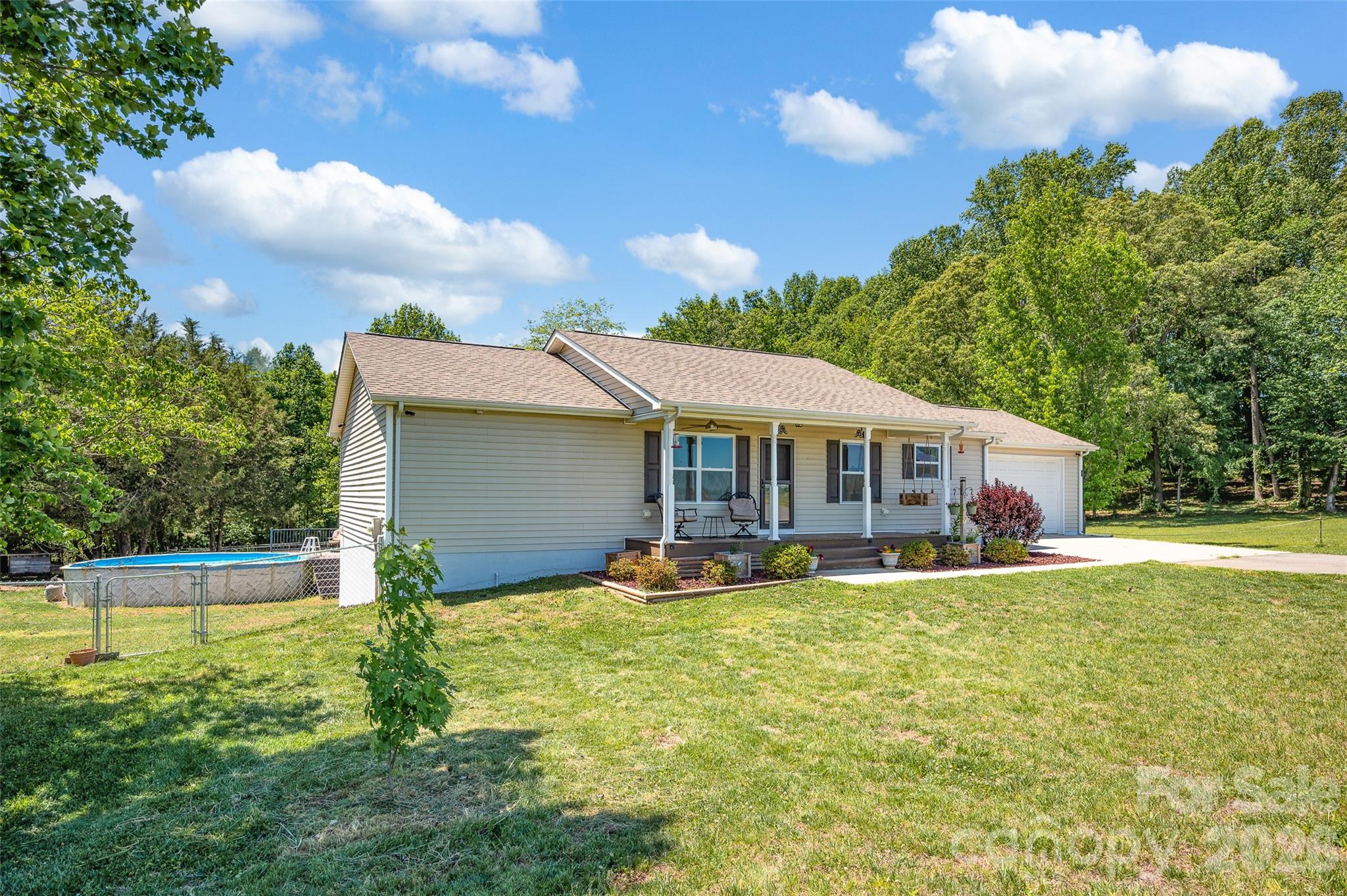 359 Rash Road Olin, NC 28660 - Photo 4 of 46 a front view of a house with garden
