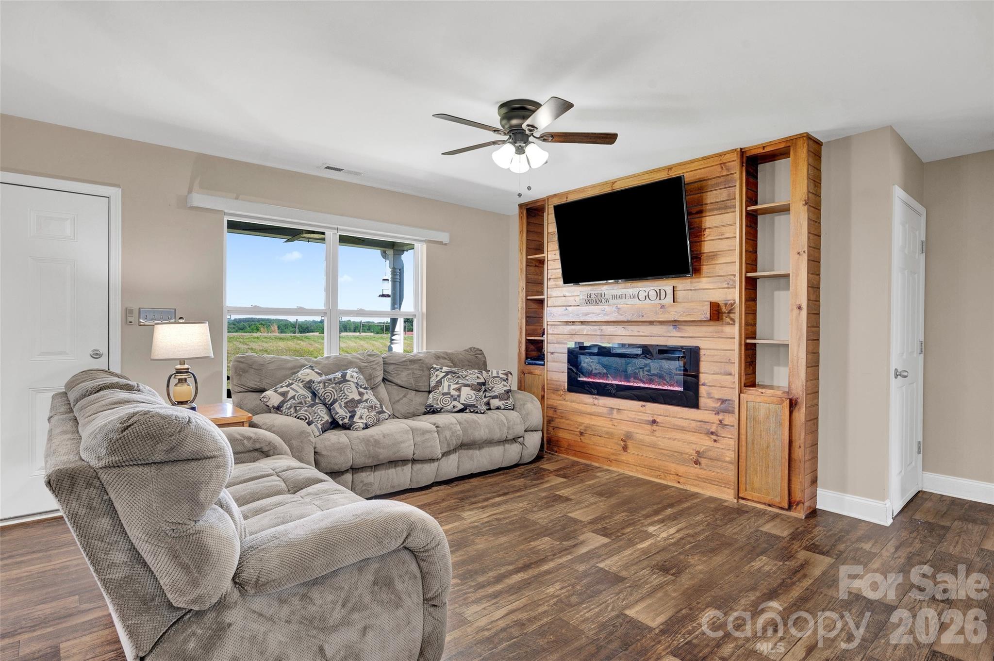 359 Rash Road Olin, NC 28660 - Photo 8 of 46 a living room with furniture a flat screen tv and a fireplace