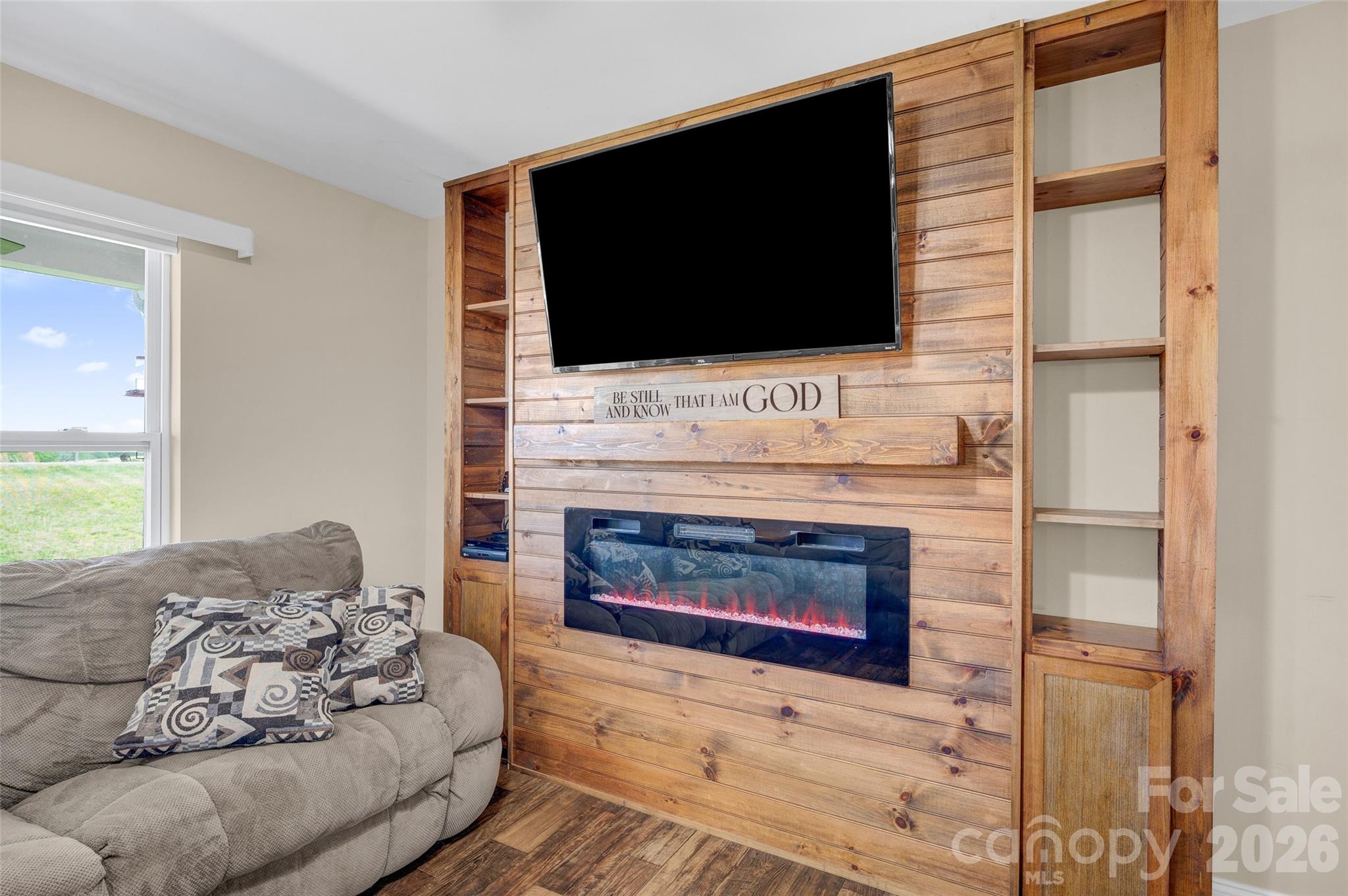 359 Rash Road Olin, NC 28660 - Photo 9 of 46 a living room with a fireplace and a flat screen tv