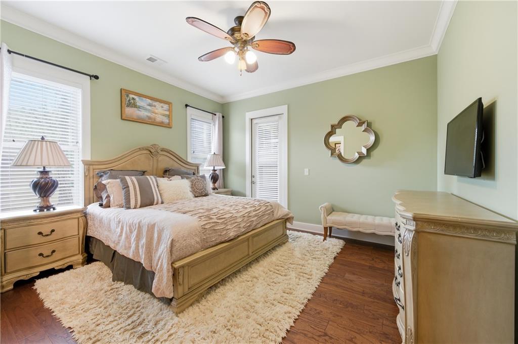 117 South Bay Road, Unit 402 Eatonton, GA 31024 - Photo 17 of 48 a bedroom with a bed and a chandelier