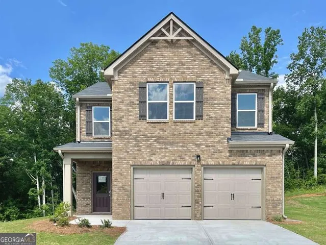 a view of front a house with yard and trees